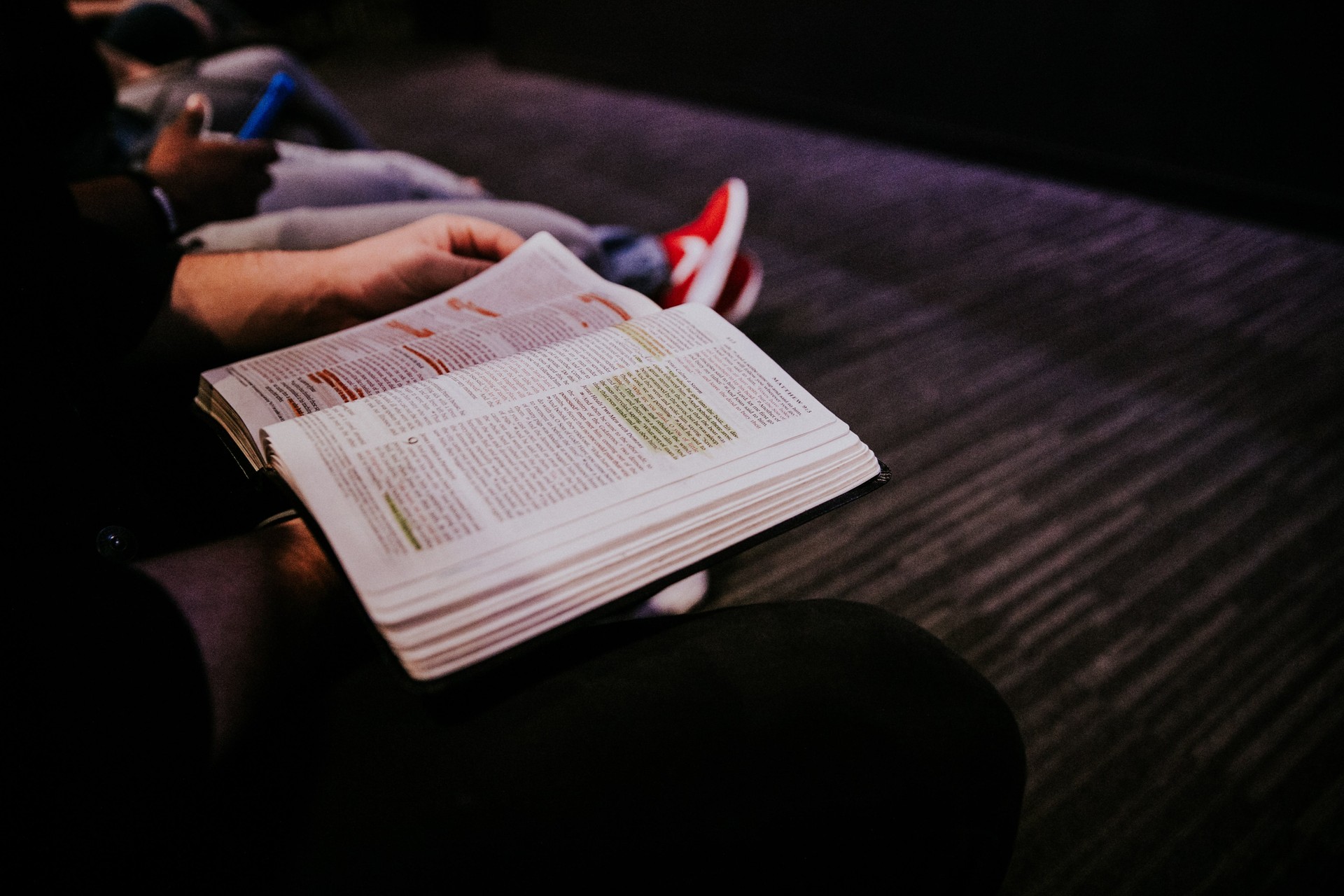Hands holding open a Bible.